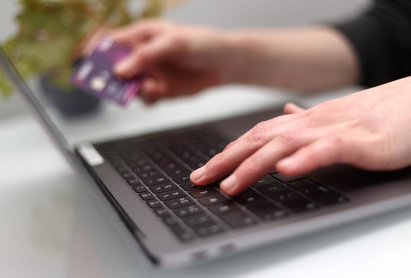 A woman using a laptop as she holds a bank card. Issue date: Wednesday November 9, 2022. PA