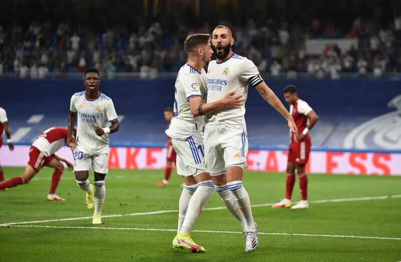 Karim Benzema of Real Madrid celebrates with teammate Federico Valverde after scoring their team's first goal. Getty Images
