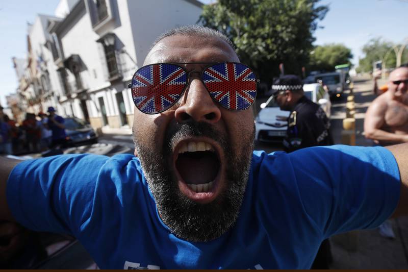 A Glasgow Rangers supporter cheers in downtown Seville. AP