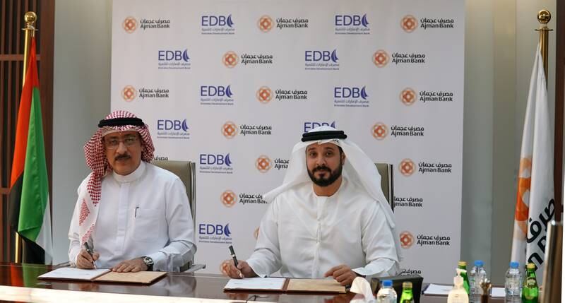 The agreement was signed by Mohamed Amiri, left, chief executive of Ajman Bank and Ahmed Mohamed Al Naqbi, chief executive of EDB. Photo: Ajman Bank