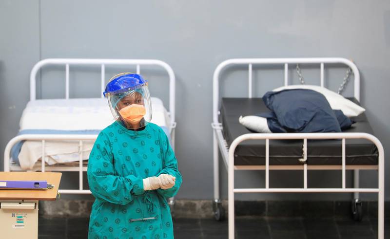 A health worker walks between beds at a temporary field hospital set up by Medecins Sans Frontieres (MSF) during the coronavirus disease (COVID-19) outbreak in Khayelitsha township near Cape Town, South Africa, July 21, 2020. REUTERS