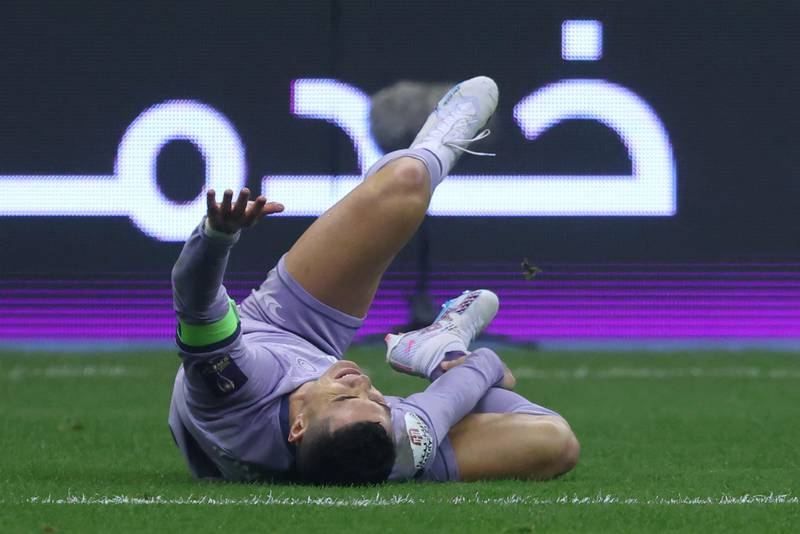 Al Nassr's Portuguese forward Cristiano Ronaldo lays on the pitch injured. AFP