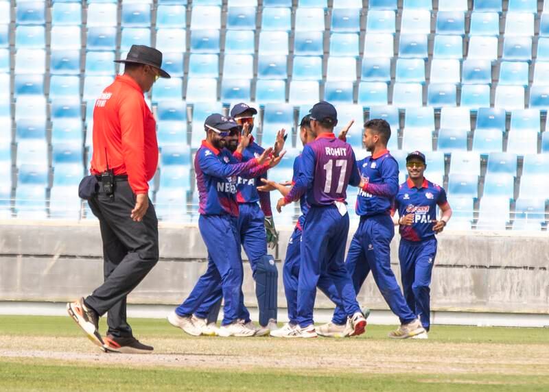 Nepal celebrate a wicket.