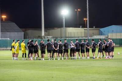 Palestine players gather around during a training session.