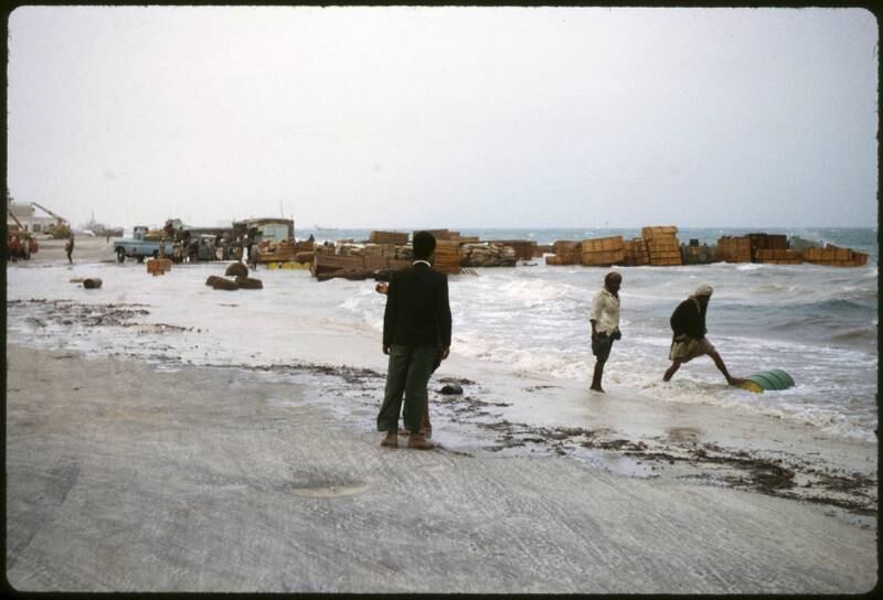 Abu Dhabi town 1962/64 On the sea front near the quay. Recently unloaded cargo caught by a Winter storm and high tide, when the sea 'surged' inshore. Photo by David Riley