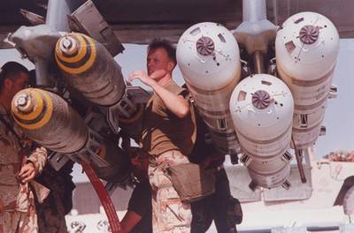 A USAF ground crew loading 500-pound bombs onto an aircraft during operation Desert Storm - the mission to drive Iraqi forces out of Kuwait, January-February 1991.  (Photo by Mark Peters/Department Of Defense (DOD)/The LIFE Picture Collection via Getty Images)