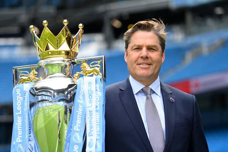 Richard Masters, chief executive of the Premier League, poses  with the Premier League trophy. Getty