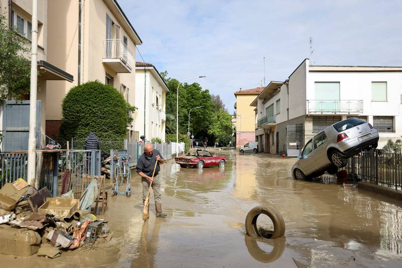 A resident in Faenza removes mud and debris after Italy's Emilia Romagna region was deluged by heavy rain. Reuters

