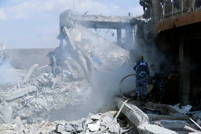 Fireman extinguish smoke that rises from the damage of the Syrian Scientific Research Center which was attacked by U.S., British and French military strikes to punish President Bashar Assad for suspected chemical attack against civilians, in Barzeh, near Damascus, Syria, Saturday, April 14, 2018. The Pentagon says none of the missiles filed by the U.S. and its allies was deflected by Syrian air defenses, rebutting claims by the Russian and Syrian governments. Lt. Gen. Kenneth McKenzie, the director of the Joint Staff at the Pentagon, also says there also is no indication that Russian air defense systems were employed early Saturday in Syria. AP Photo/Hassan Ammar