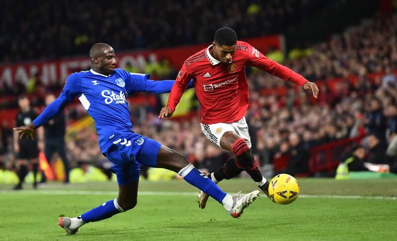 Everton's Abdoulaye Doucoure battles for the ball with Marcus Rashford. EPA