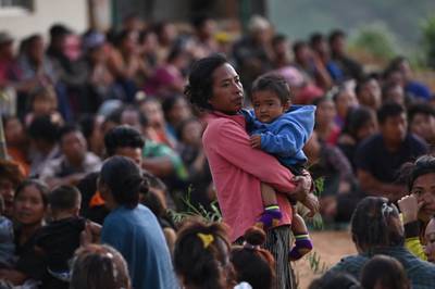Displaced people, many of whose homes were burnt down, have sought refuge at a temporary shelter in a military camp. AFP