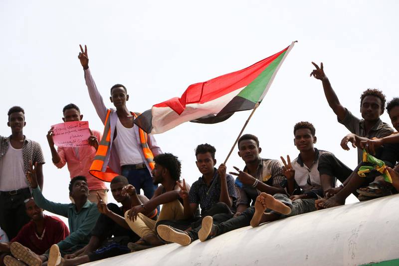 Sudanese pro-democracy supporters celebrate a final power-sharing agreement with the ruling military council, in the capital, Khartoum.  AP