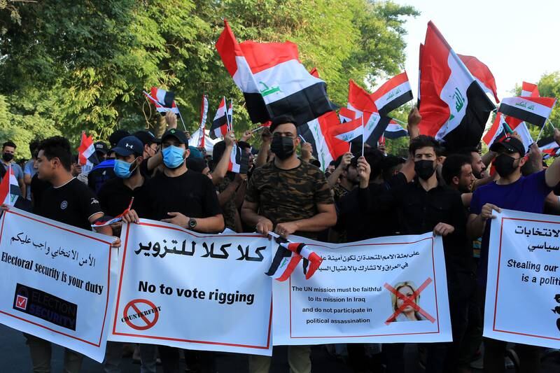 Supporters of Iran-backed Iraqi Shiite armed movements carry banners as they take part in a protest near the gate of the governmental Green Zone in central Baghdad. EPA