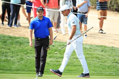 Eddie Pepperell of England and Bryson DeChambeau of the United States look on from the second hole. Getty