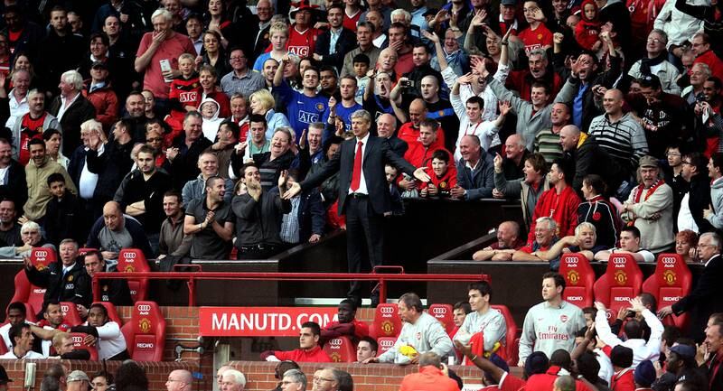 Arsenal manager Arsene Wenger is sent off by Mike Dean at Old Trafford. Wenger couldn’t find a seat in the already full Directors' Box so stood on the roof of the tunnel much to the amazement of Gary Neville (bottom left), and the amusement of the Manchester United fans. 29/08/2009. Carl Recine / FPA / LDY Agency