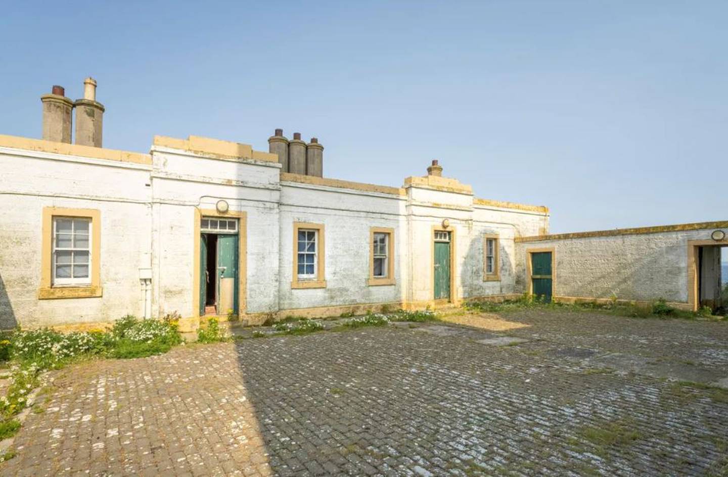 The island has a five-bedroom former lighthouse-keeper’s cottage and a separate one-bedroom cottage. Photo: Knight Frank