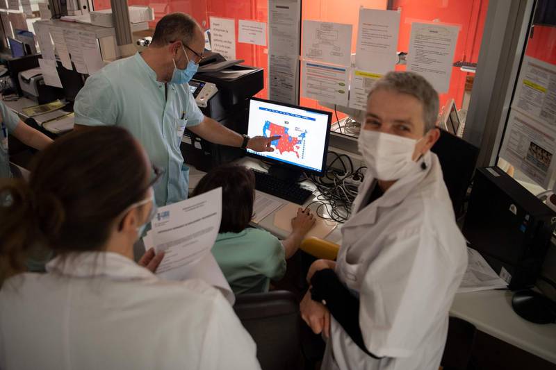 Medical workers look at a computer screen displaying the partial results of the US elections, at the intensive care unit for patients infected by Covid-19 of the university-affiliated hospital Cavale Blanche in Brest, western France. AFP