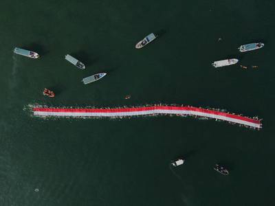 A group of 145 swimmers join an effort to stretch a 78-metre-long national flag in the sea to mark Indonesia's 78th Independence Day in Makassar, South Sulawesi. AFP
