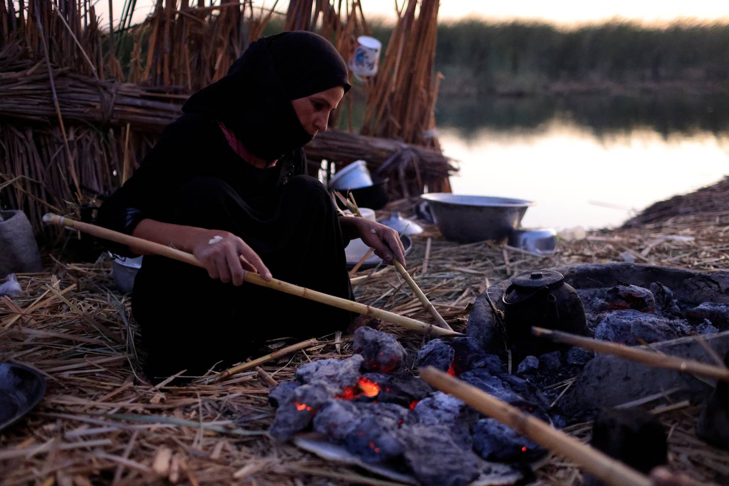 A woman makes breakfast at home in the Chebayesh marsh, Dhi Qar province, Iraq, August 15. Reuters