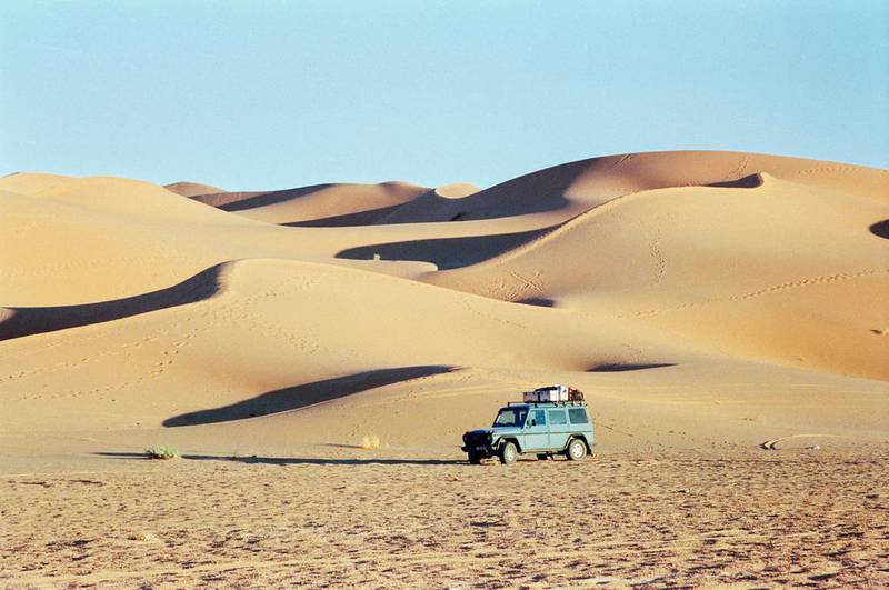 Gunther Holtorf and his trusty Mercedes-Benz G-Class, which is nicknamed Otto, on their 899,592-­kilometre round-the-globe trip in Libya. Courtesy Gunther Holtorf