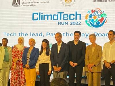 Egyptian ministers Yasmine Fouad, third from left, Rania Al Mashat and Amr Talaat, with some of the project partners. Nada El Sawy / The National