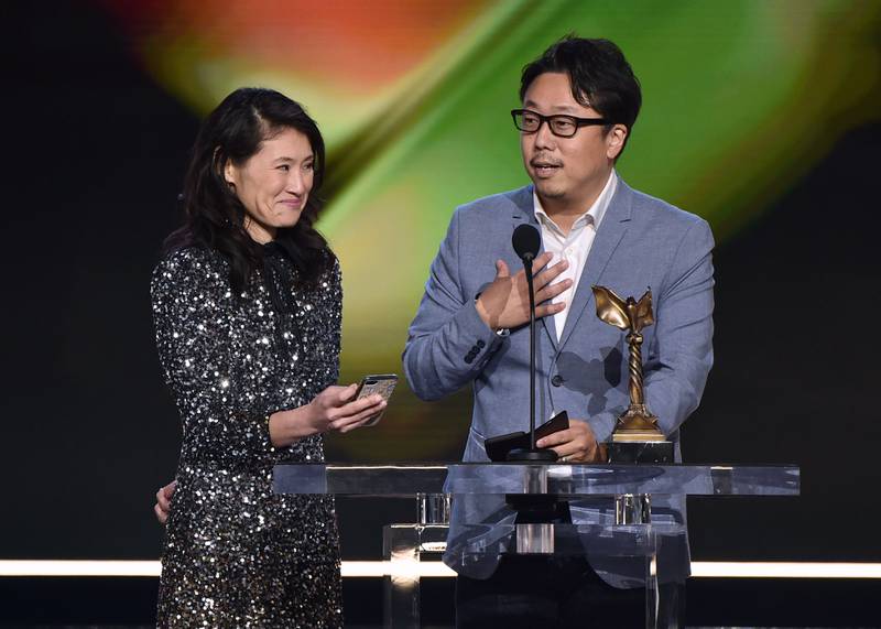 Teruhisa Yamamoto, right, accepts the Best International Film award for 'Drive My Car'. AFP