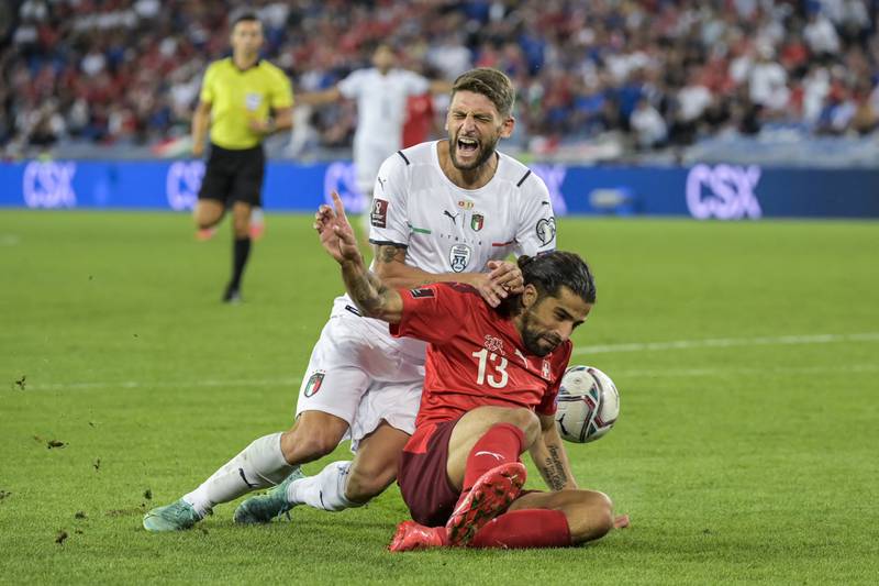 Italy's Domenico Berardi, left, is fouled by Switzerland's Ricardo Rodriguez. AP