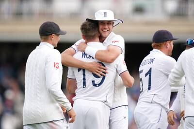 England's Chris Woakes is congratulated by Stuart Broad after the wicket of Australia's Steve Smith. PA 