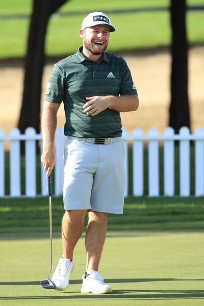 Tyrrell Hatton of England shares a joke on the putting green. Getty Images