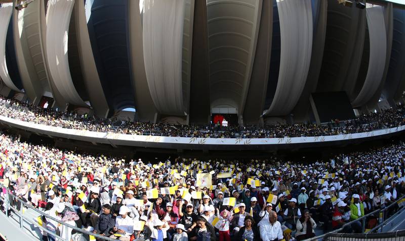 A picture taken with a fish eye lens shows thousands of people attending Mass at Zayed Sports City in Abu Dhabi.  EPA