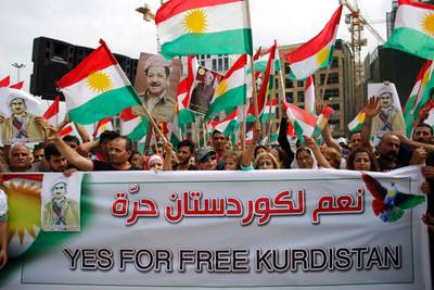 File - In this Sunday, Sept. 17, 2017 file photo, Kurds wave Kurdish flags during a rally to support an independence referendum in Iraq, at Martyrs Square in Downtown Beirut, Lebanon. On Monday Sept. 18, 2017, Iraq's Supreme Court issued a temporary ban on a Kurdish autonomous region's referendum on independence scheduled for Sept. 25. (AP Photo/Hassan Ammar)