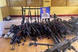 Seized weapons of the Myanmar army with the photo of Senior Gen Min Aung Hlaing in a rebel outpost in Shan state this month. The Tatmadaw has faced severe setbacks in recent weeks. AP