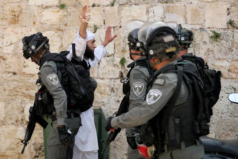 A Palestinian gestures as he confronts Israeli police during clashes at the compound that houses Al Aqsa Mosque on May 10. Reuters