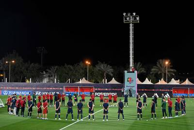 Portugal players and staff observe a minute's silence for former Portugal and Porto striker Fernando Gomes during a team training session at Al Shahania SC in Al Samriya, northwest of Doha. AFP