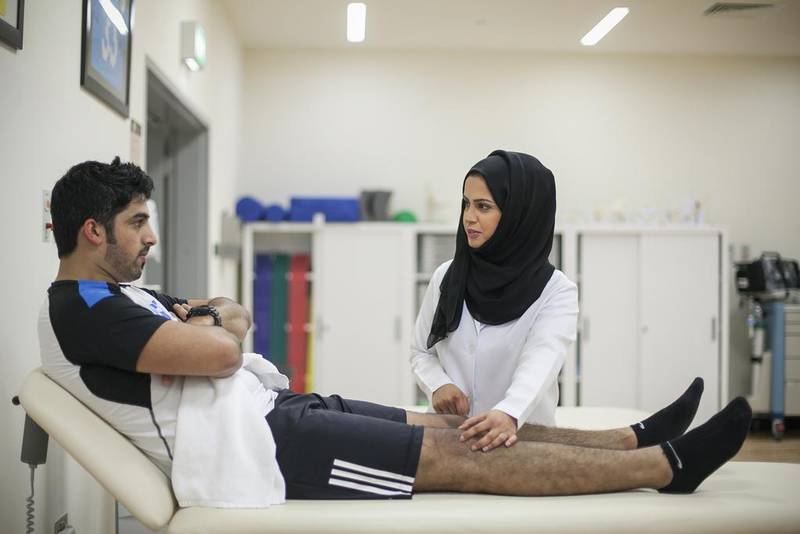 Emirati physiotherapist Marwa Al Hosani with a patient at Healthpoint orthopaedic centre in Abu Dhabi. Mona Al Marzooqi / The National