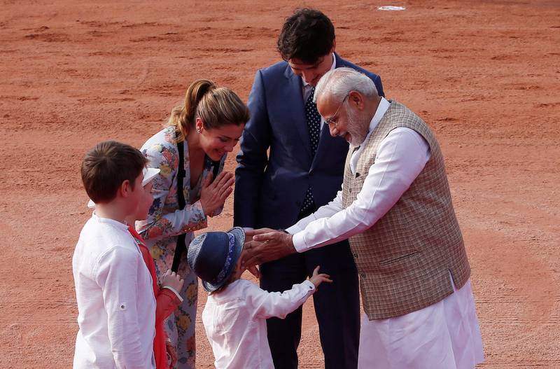 Mr Modi greets Mr Trudeau's son Hadrien during the ceremonial reception for his father. Adnan Abidi / Reuters