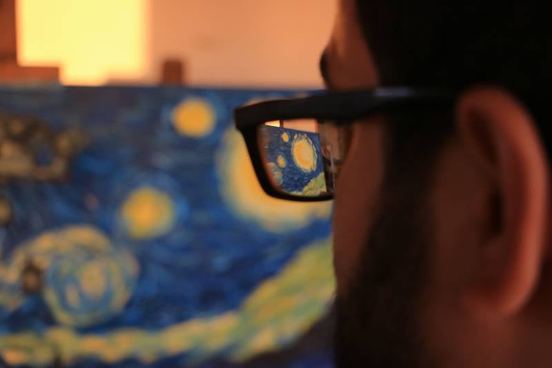Al Shami looks at his finished picture. Abd Almajed Alkahr/The National