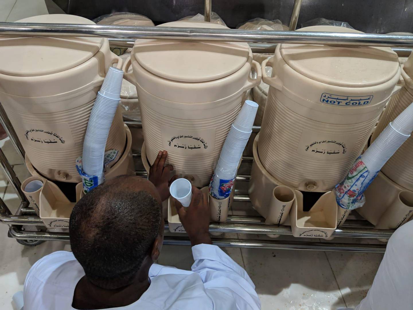 Containers of zamzam water are distributed across the mosque