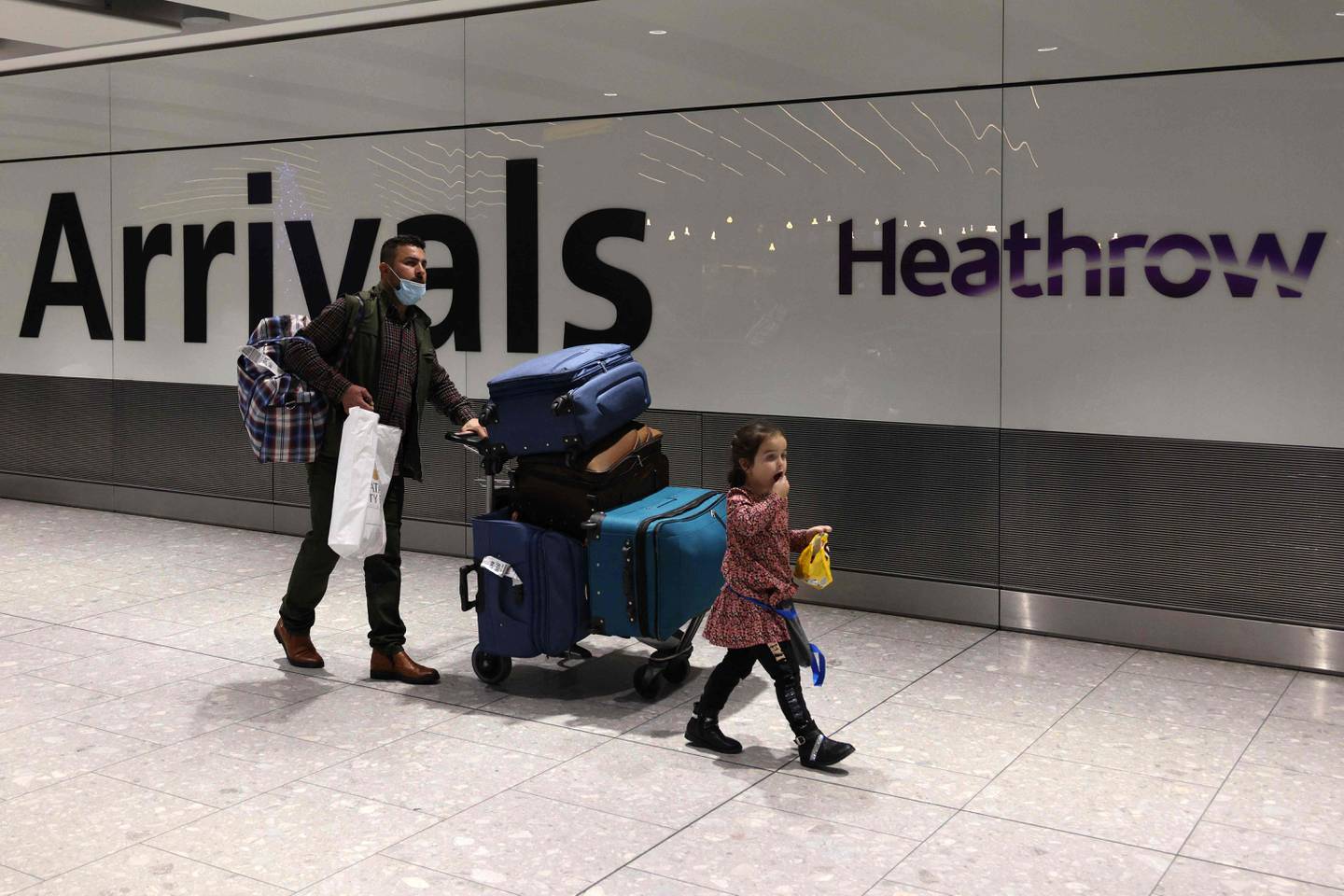 People arrive at London Heathrow Airport on the day the new restrictions took effect. AFP
