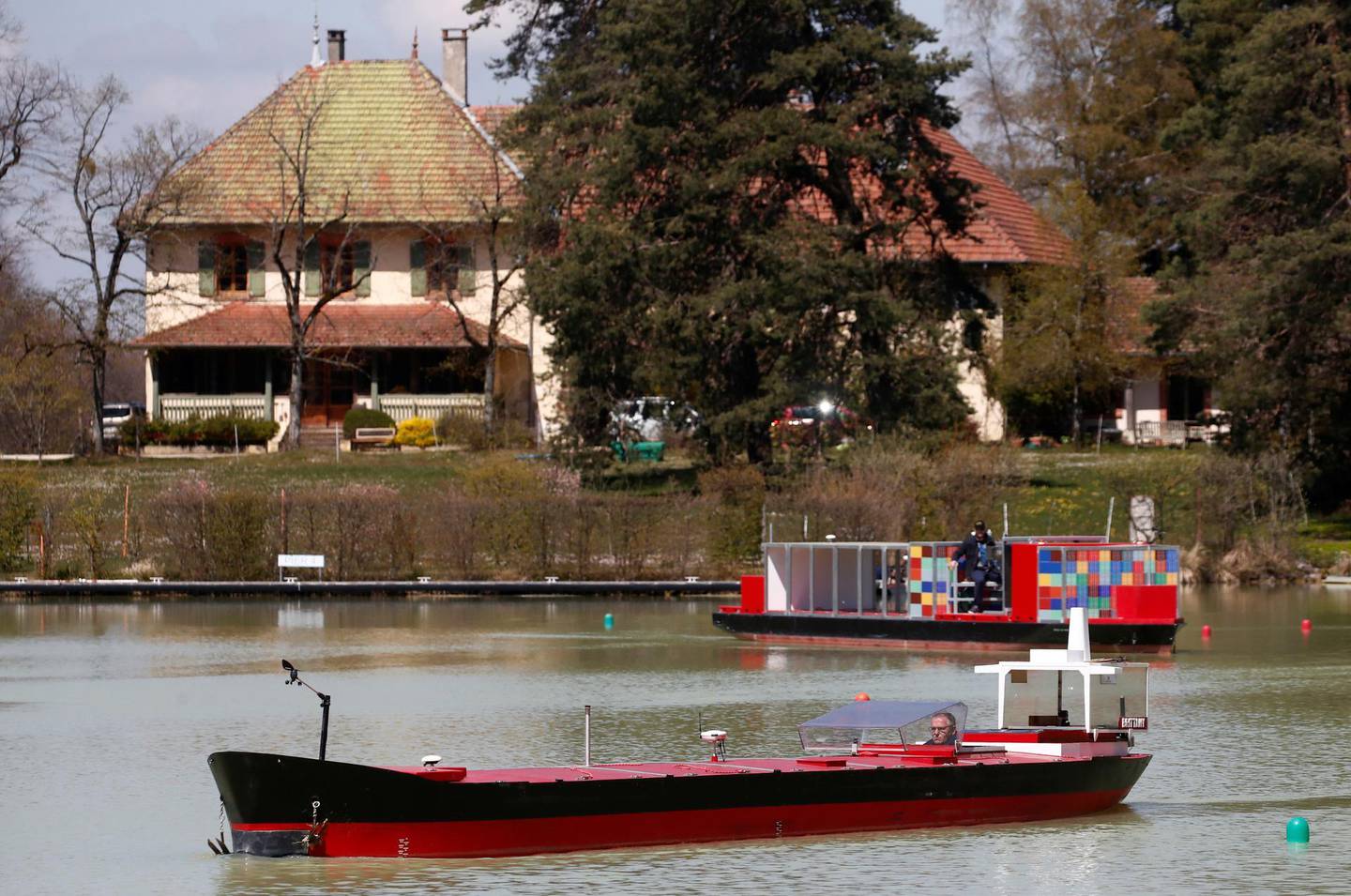 Francois Mayor, managing director of Port Revel, steers a scaled-down model of a tanker, named the Brittany, on a lake at the Port Revel Shiphandling Training Centre in Saint-Pierre-de-Bressieux, France, April 19, 2021. Picture taken April 19, 2021. REUTERS/Stephane Mahe