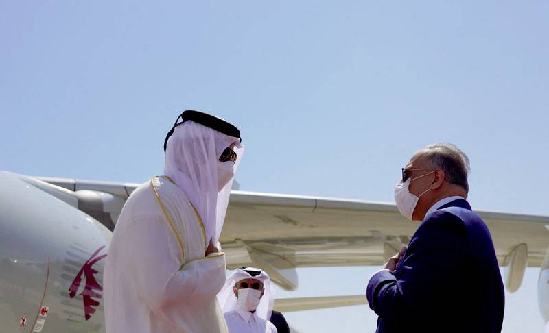Iraqi Prime Minister Mustafa Al Kadhimi greets Qatar’s Emir Sheikh Tamim on his arrival in Baghdad. AFP