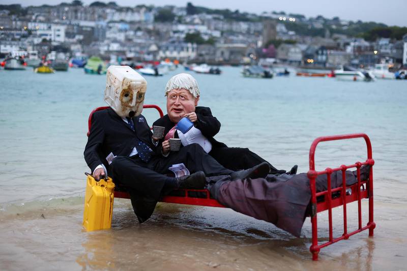 Activists from climate action group Ocean Rebellion demonstrate in St Ives Harbour. Reuters