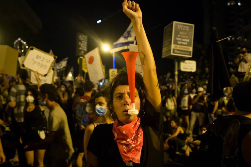 JERUSALEM, ISRAEL - AUGUST 01:  Israeli woman raise her hand during a demonstration against Israeli Prime Minister Benjamin Netanyahu on August 1, 2020 in Jerusalem, Israel. The protests have become a recurring feature amid discontent over the the government's handling of the coronavirus pandemic and Netanyahu's looming corruption trial.  (Photo by Amir Levy/Getty Images)