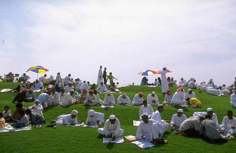 Race-goers sit on a hill to watch the fourth Dubai World Cup in 1999 at Nad Al Sheba racecourse. Julian Herbert / Allsport