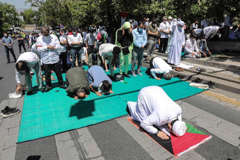 At a demonstration In front of the Israeli embassy in Ankara, Turkey, the Palestinian flag is used as a mat for funeral prayers for people killed in Palestine. AFP