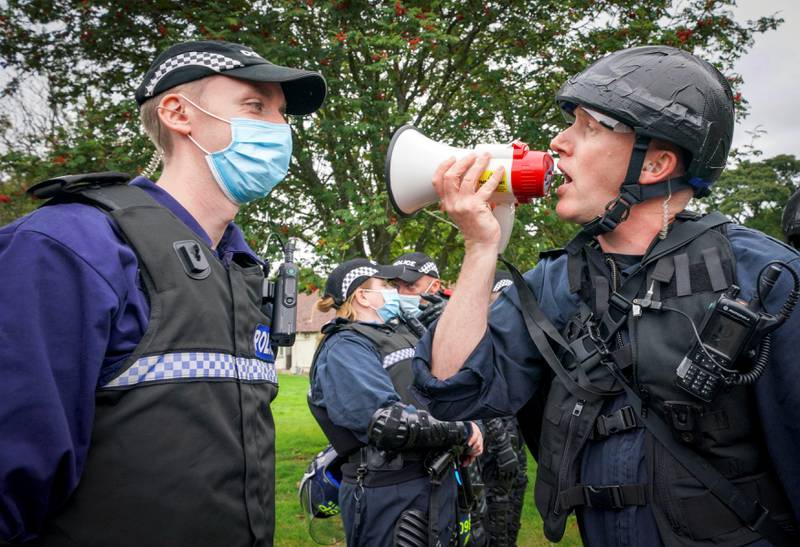 Scottish police officers take part in role-play exercise, recreating a protest during Cop26 public order training. Reuters