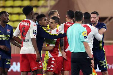 Players fight a the end of the L1 football match between Monaco (ASM) and Lyon (OL) at The Louis II Stadium, in Monaco on May 2, 2021. / AFP / Valery HACHE