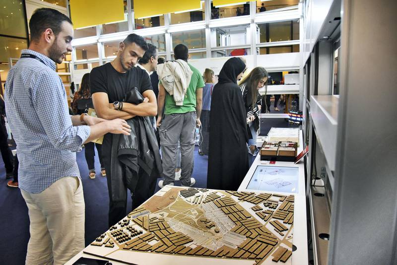 An exhibitor, left, explains his project at the Global Grad Show during the Dubai Design Week at the Dubai Design District, Dubai, UAE, on Monday, Nov. 11, 2019. (Photos by Shruti Jain - The National)