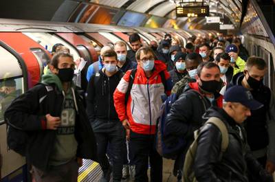Commuters travel through Vauxhall underground station in London. Reuters