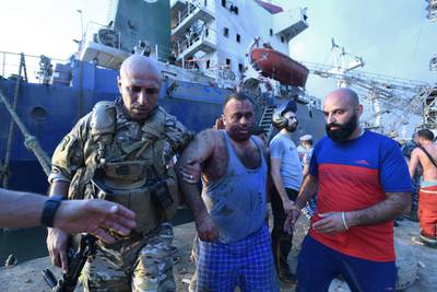 Lebanese army troops carry a wounded man evacuated from a ship at Beirut's port.  AFP